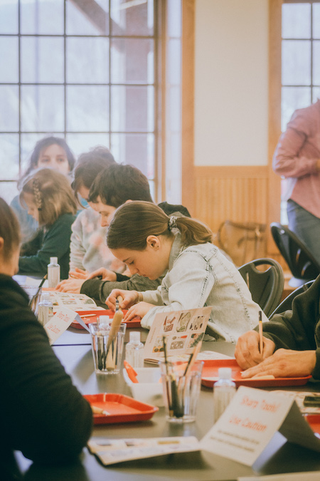 Photo of children making art at MN Marine Art Museum.