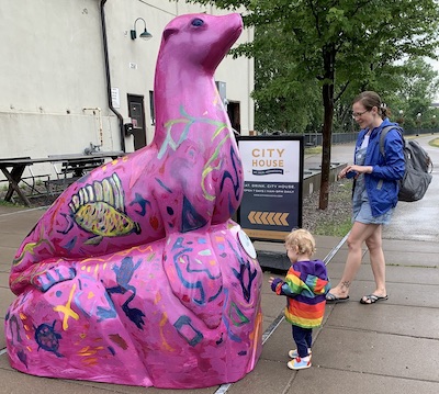 Photo of large, pink & bright-colored sea lion statue painted by Joan Porter-Einsman.