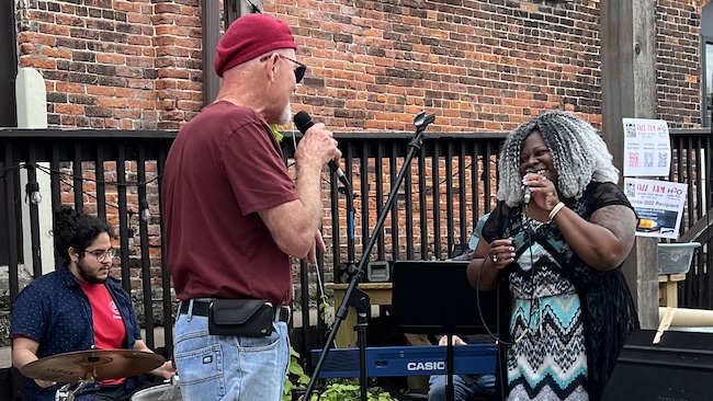 Saint Mary’s student Jostin Alvarado (drums) sits in with Winona’s John Carrier and Rochester celebrity LaSonya Natividad.