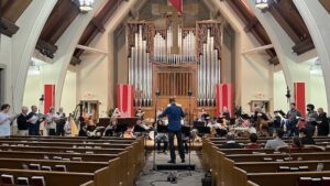 Photo of an orchestra and choir performing at Central Lutheran Church.