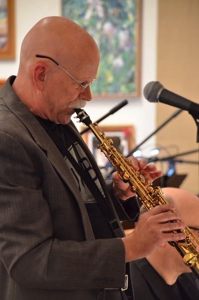 Photo of John Paulson playing saxophone.