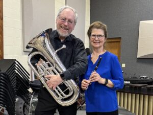 Photo of Eric and Janet Heukeshoven with musical instruments.