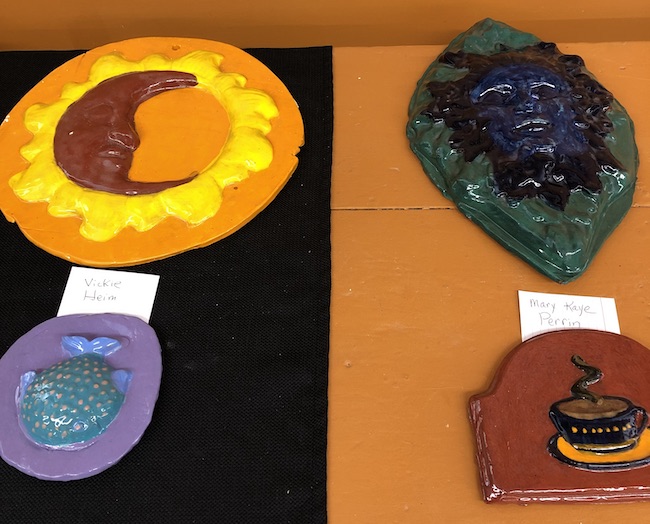 Photo of several painted ceramic press mold pieces.