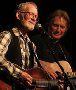 Photo of Johnsmith & Dan Sebranek performing with guitars.