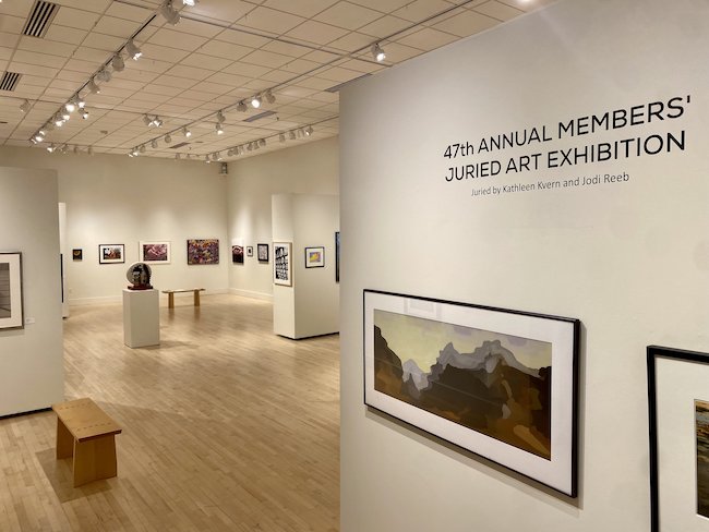 Image showing artworks displayed in a gallery with wall label text "47th Annual Members Juried Art Exhibition".