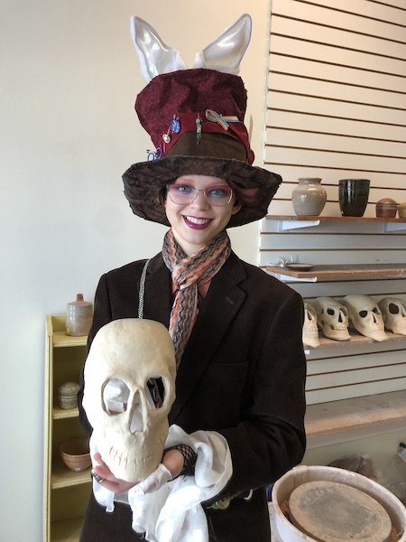 Participant holding a ceramic skull at Island City Clayspace.