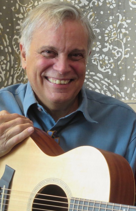 Photo of Hans Mayer with a guitar.