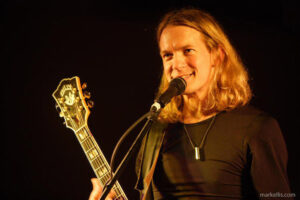 Photo of Billy McLaughlin performing with guitar.