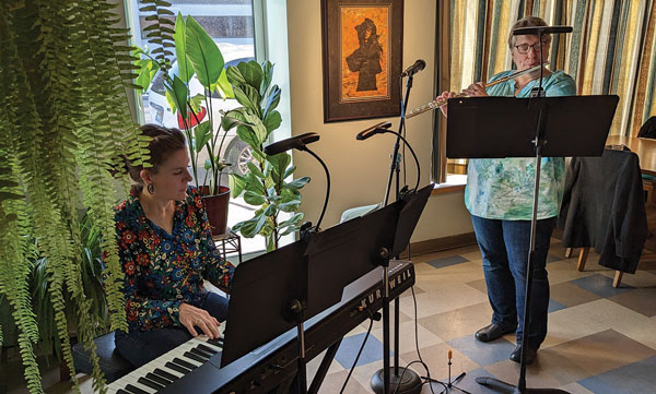 Photo of Meredith Mihm and Heidi Bryant performing on keyboard and flute at the Blue Heron Coffeehouse.