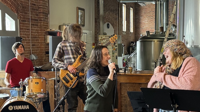 Winona Community HUB director Jackie Henderson (left) jams with H3O and Shelby Lynn. 