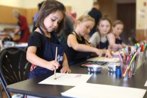 Children painting at a Seasonal Saturday event.