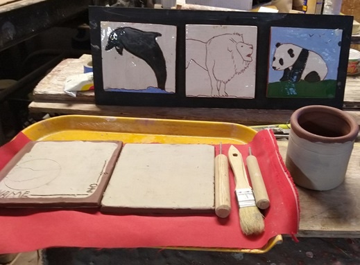 Photo of a pottery tray with sgraffito-decorated tiles.