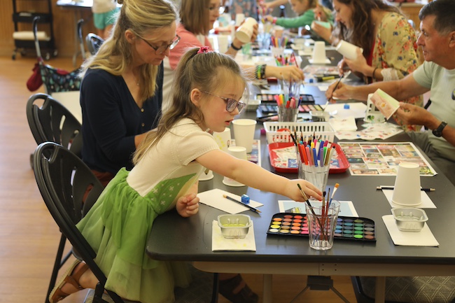 Image of people working on an art activity at a MMAM Seasonal Saturday.