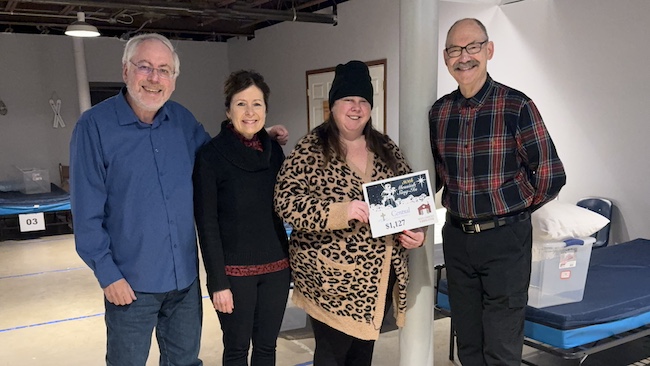 BellaMusica singer Lauren Mechell, Central’s Director of Worship, Music & Arts A. Eric Heukeshoven, Warming Center staff Jennifer Elesson, and Messiah music director Dr. Harry Mechell exchange a donation for the Warming Center from the Messiah Sing-in.