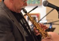 Photo of John Paulson playing saxophone.