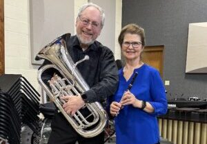 Photo of Eric and Janet Heukeshoven with musical instruments.