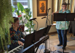 Photo of Meredith Mihm and Heidi Bryant performing on keyboard and flute at the Blue Heron Coffeehouse.