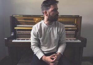 Photo of Philip Daniel with a piano.