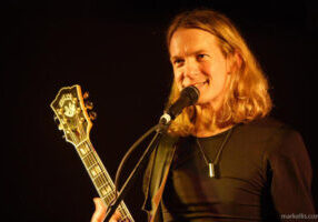 Photo of Billy McLaughlin performing with guitar.