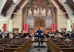 Photo of an orchestra and choir performing at Central Lutheran Church.