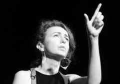 Black-and-white photo of storyteller Clare Murphy performing.