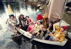 Photo of FLOTSAM! River Circus performers in a boat.