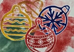 Monoprinted card featuring colorful holiday ornaments.