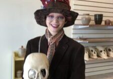 Participant holding a ceramic skull at Island City Clayspace.