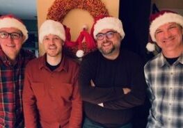 Photo of the members of Johnson Street Underground wearing Santa hats.