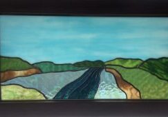 A stained glass River Window by Jack Honeywell.