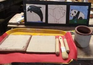 Photo of a pottery tray with sgraffito-decorated tiles.